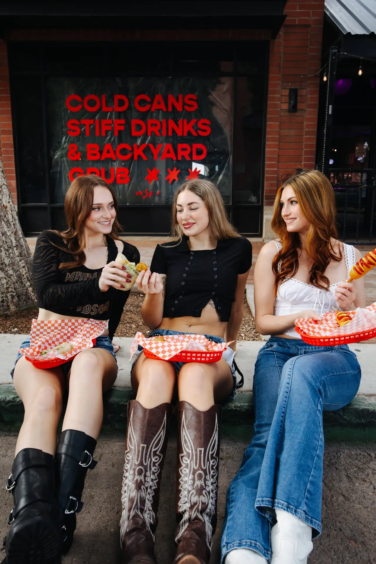 Friends eating corn dogs and fries at Neon Spur