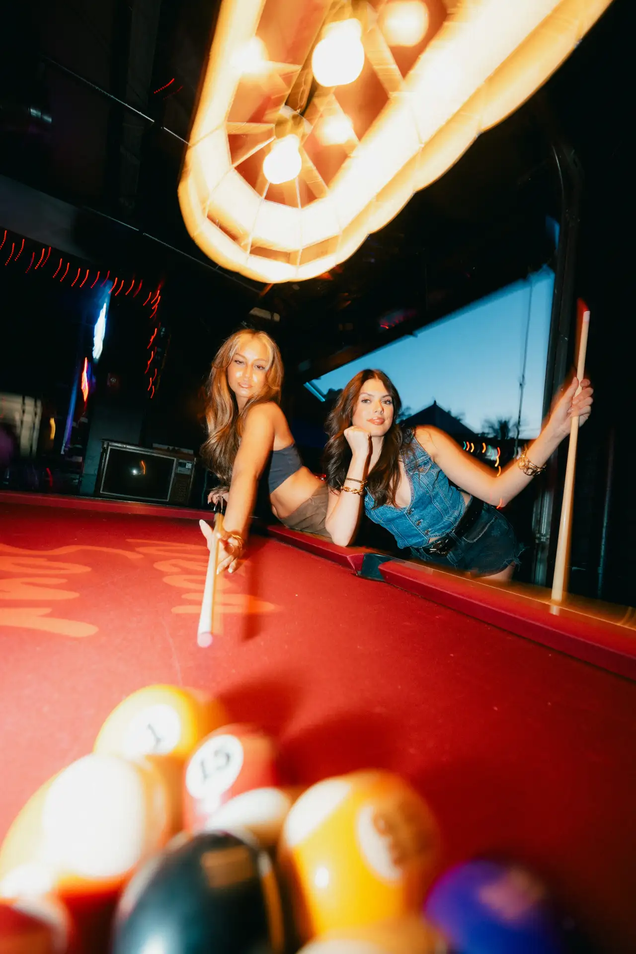 Friends playing pool at Neon Spur